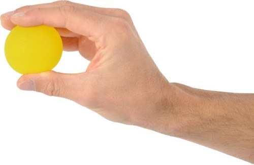 Ręka ściskająca piłkę Squeeze Ball w naturalnej pozycji — przykład ćwiczenia poprawiającego siłę palców i nadgarstka