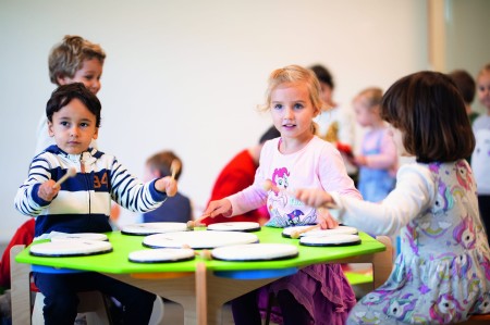 Zestaw perkusyjny NINO966 Classroom z wyjmowanymi bębnami i drewnianym stojakiem w sali muzycznej