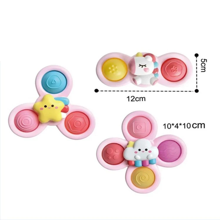 Dziecko obraca kosmiczny spinner Pop-it WOOPIE BABY z motywem jednorożca — uchwycony ruch i kolor