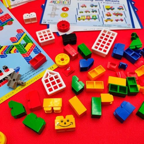 Zbliżenie na modele zbudowane z zestawu Master Builder: domki, wieże i pojazdy ilustrujące możliwości kreatywne.