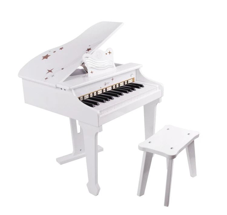 Instrukcja i książeczka edukacyjna obok pianina CLASSIC WORLD — komplet do nauki gry dla dzieci