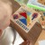 Kadr z rozłożonymi elementami Tangram 18el. TOOKY TOY pokazuje kombinacje kształtów i wzorów