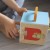 Kolorowe elementy do sortowania ułożone obok pudełka — praktyczny zestaw edukacyjny Tooky Toy