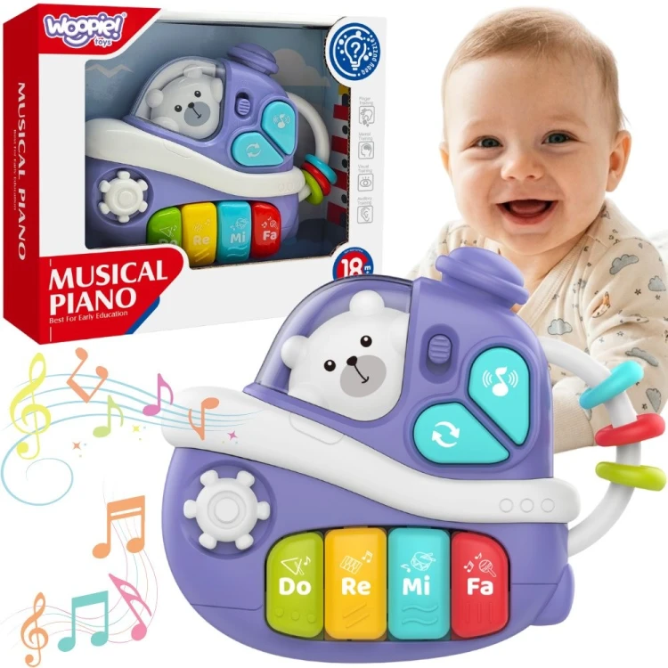 Interaktywne muzyczne pianinko WOOPIE BABY w kształcie fioletowego statku z białym misiem w okienku