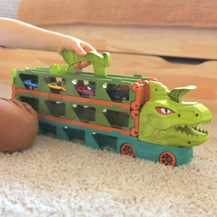 Ciężarówka Dinozaur WOOPIE rozłożona do transportu — widoczne schowki i miejsce na segmenty toru