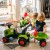 Akcesoria do zestawu FALK Baby Claas ułożone obok pojazdu — przegląd dodatków do zabawy widocznych przy traktorku