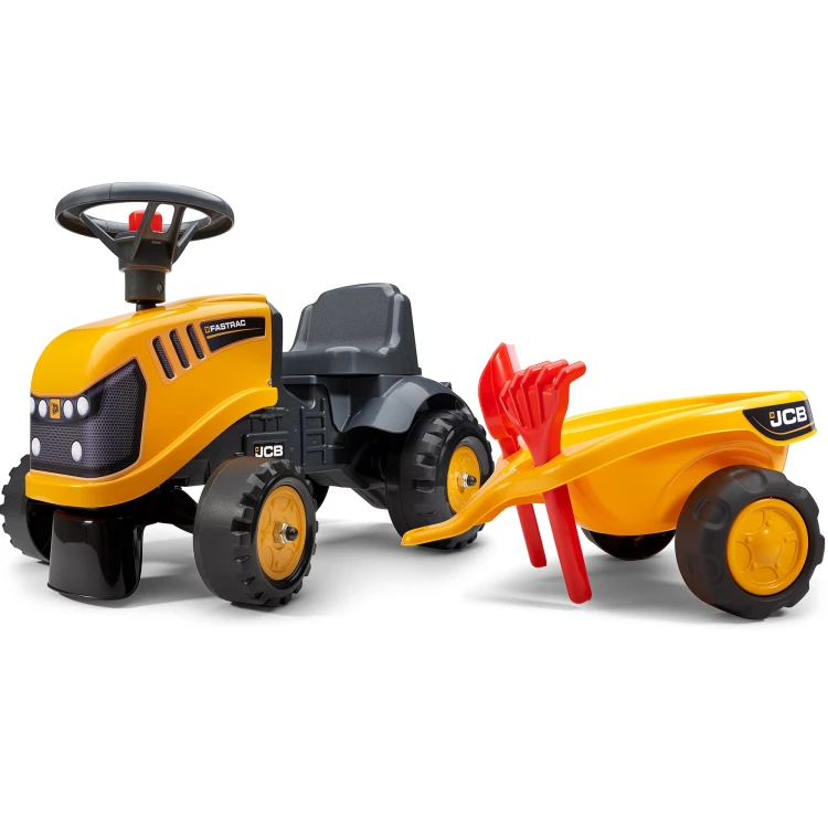 Traktorek JCB FALK pomarańczowy — ujęcie skośne pokazujące całą sylwetkę i przyczepkę z boku