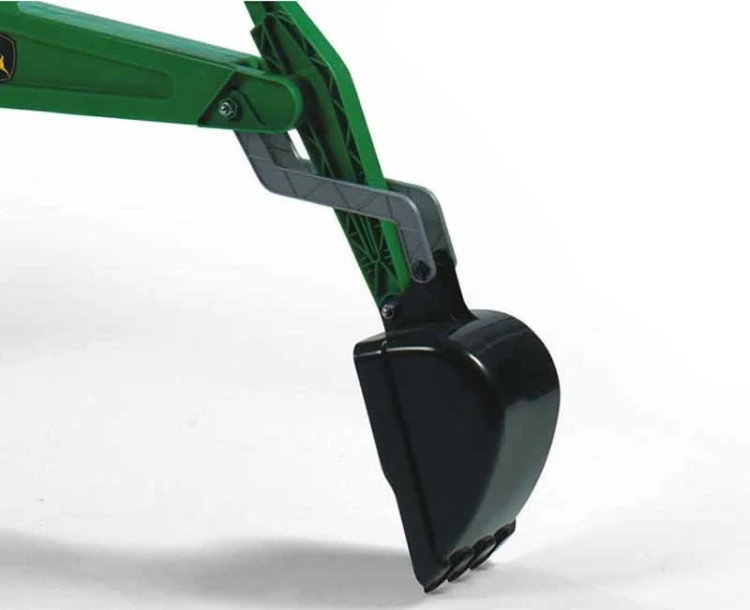 Widok z góry na RollyBackhoe Rolly Toys — całe ramię koparki, łyżka i podwozie ustawione na trawie
