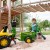 Zbliżenie na otwierane burty przyczepki Rolly Toys John Deere — widoczny mechanizm zaczepu i przestrzeń ładunkowa