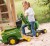 Boczny kadr koparki Rolly Toys RollyDigger — detal fotela, drążka sterowania i łyżki po stronie