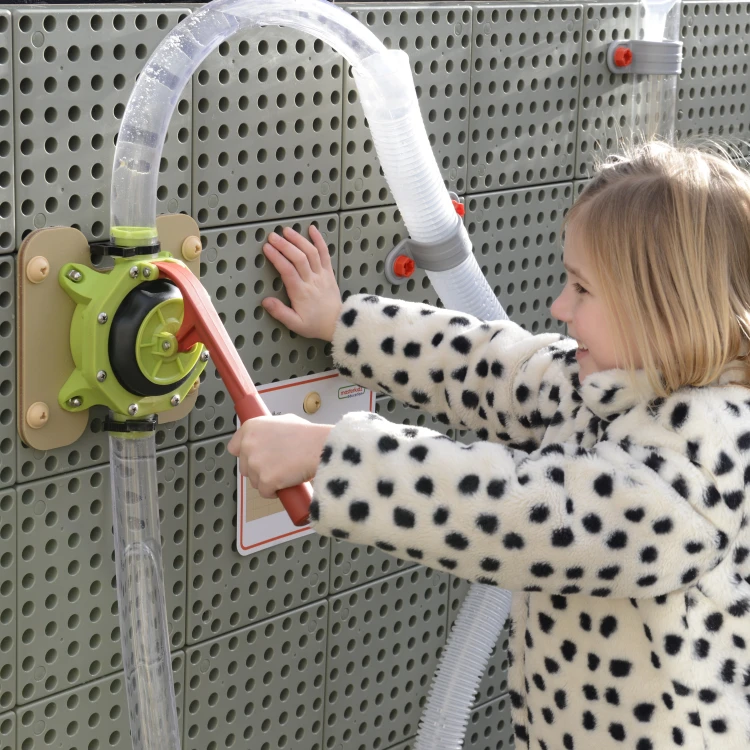 Zbliżenie pompki wodnej MASTERKIDZ — mechanizm zaworu i przewody widoczne na tablicy edukacyjnej