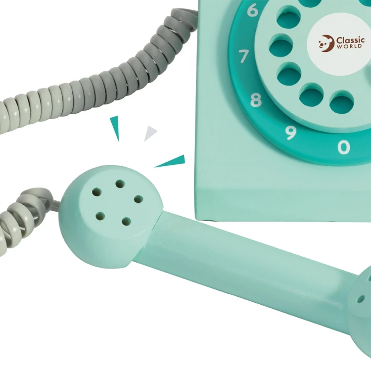 Ujęcie z góry na telefon CLASSIC WORLD - tarcza, słuchawka i elementy dekoracyjne widoczne na powierzchni zabawki
