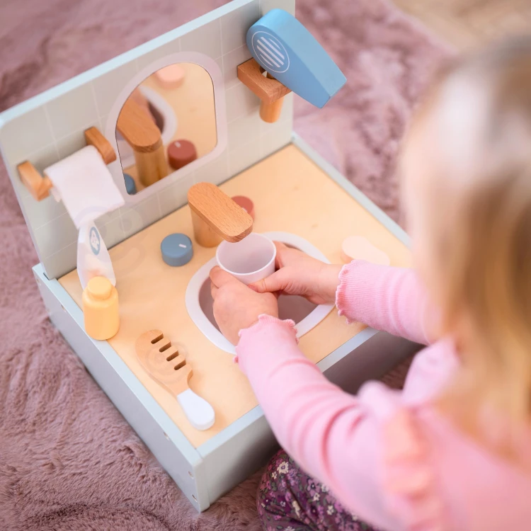 Bok zabawnej toalety TOOKY TOY — widok boczny z dołączonymi akcesoriami i drewnianymi detalami.