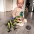 Dramatyczne oświetlenie sylwetki WOOPIE T-Rex — profil dinozaura i faktura łusek w półmroku