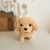 Tył maskotki z metką i starannym szwem, pluszak Bichon Golden Retriever WOOPIE — widok z tyłu