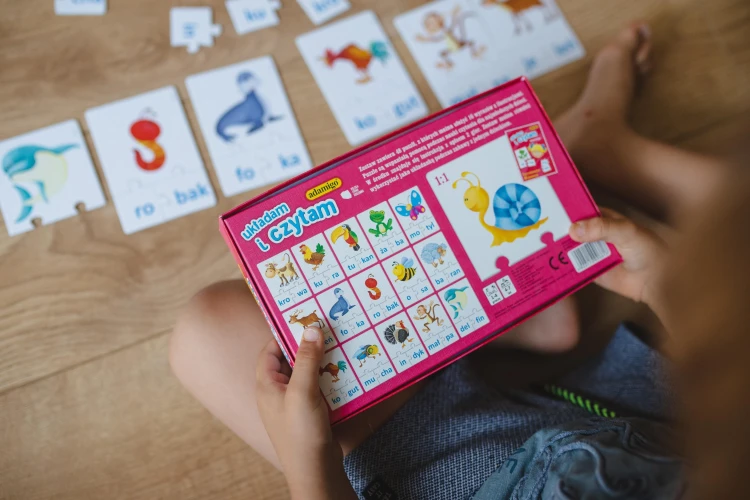 Zbliżenie na puzzle Układam i Czytam ADAMIGO z kolorowymi ilustracjami wyrazów